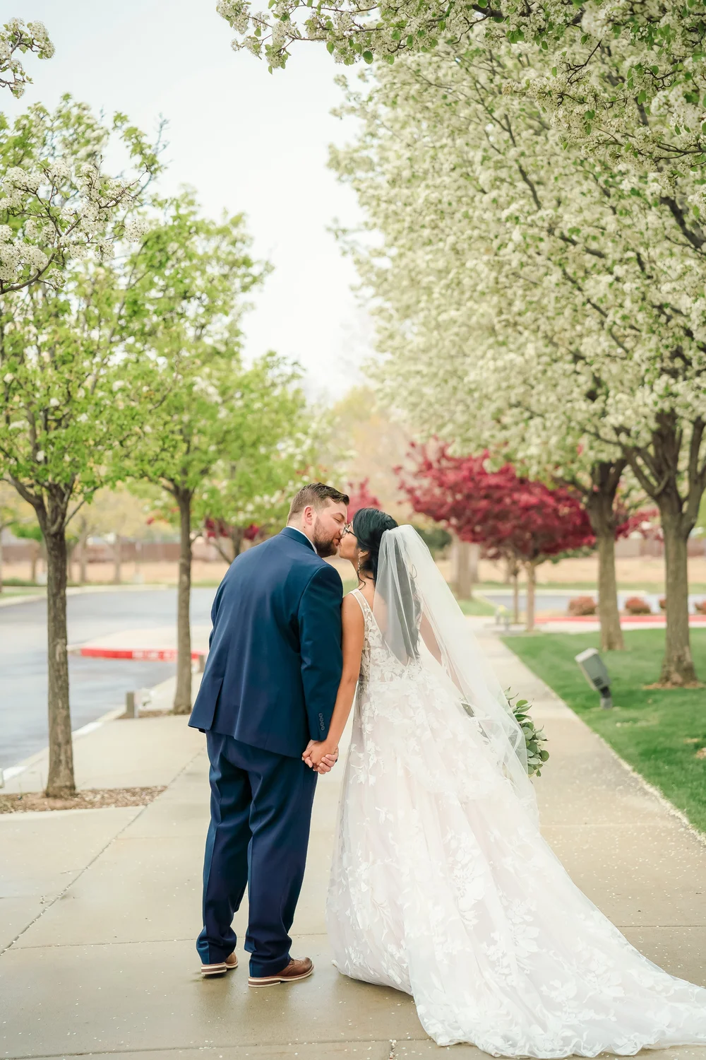 Couple kissing under spring blossoms