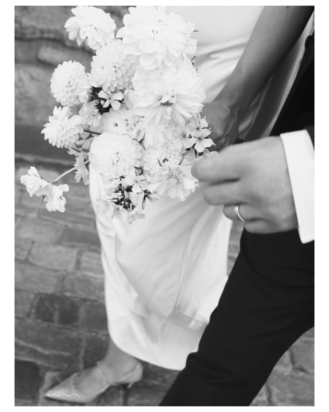 A lot of hands and a pair of shoes.
Black and white details from last season.