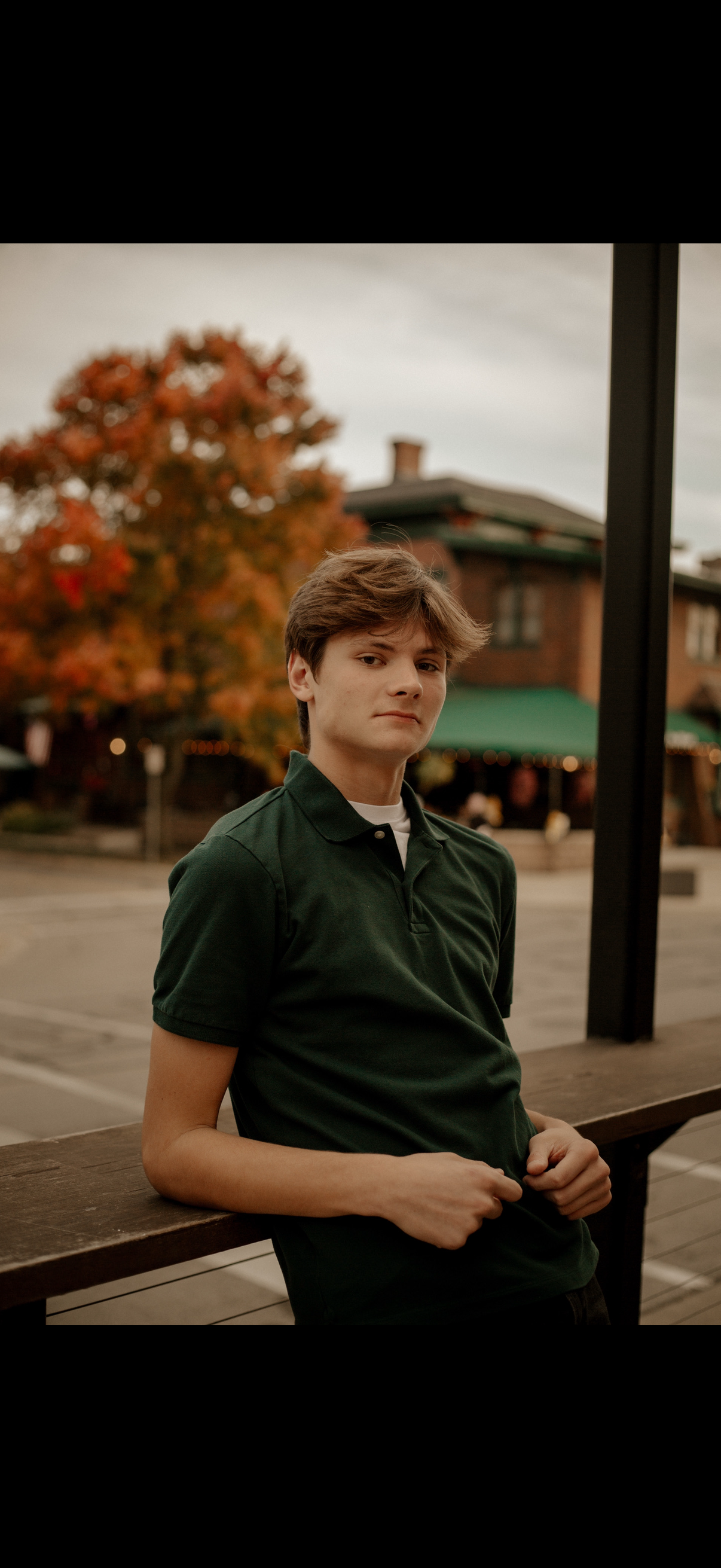 Picture of Nathan Bermudez, a Latino man, wearing glasses and a white cable knit sweater 