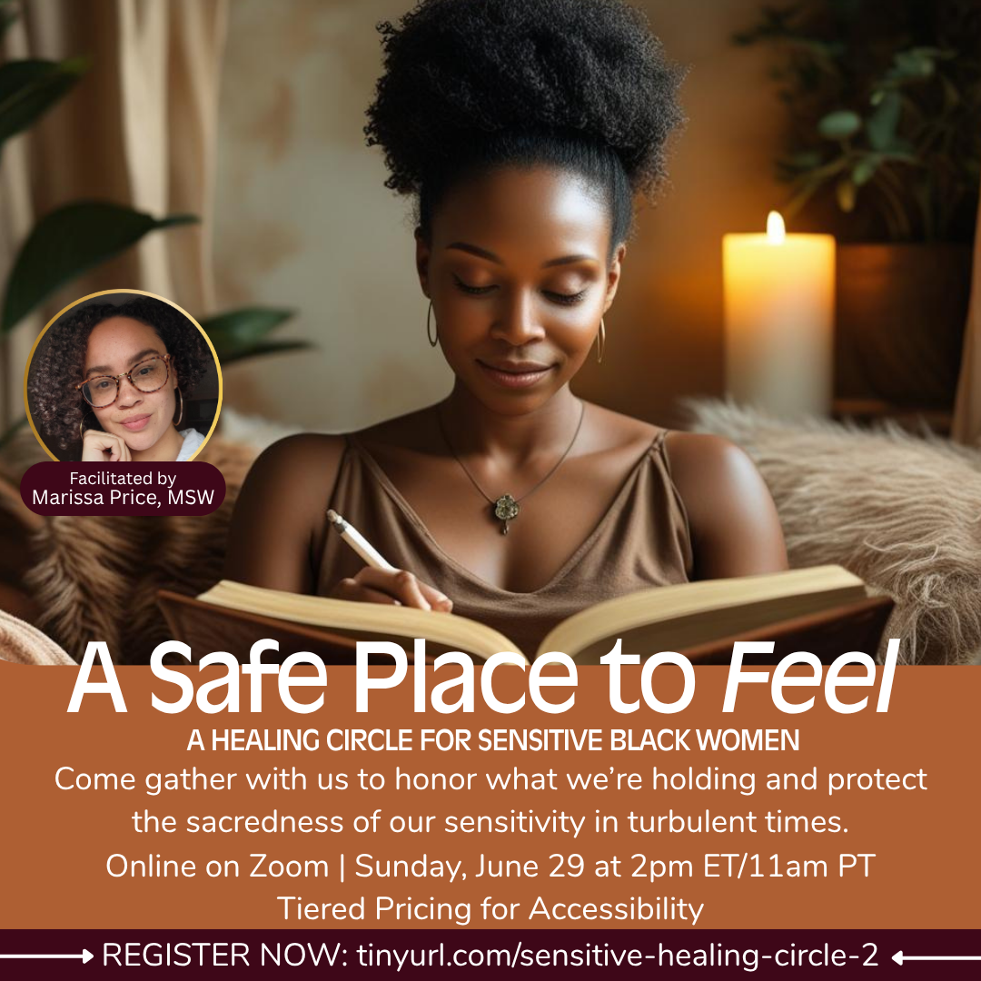 A woman with dark curly hair in a high puff, wearing a satin brown top and jewelry, sitting on a cozy blanket with a lit candle in the background.