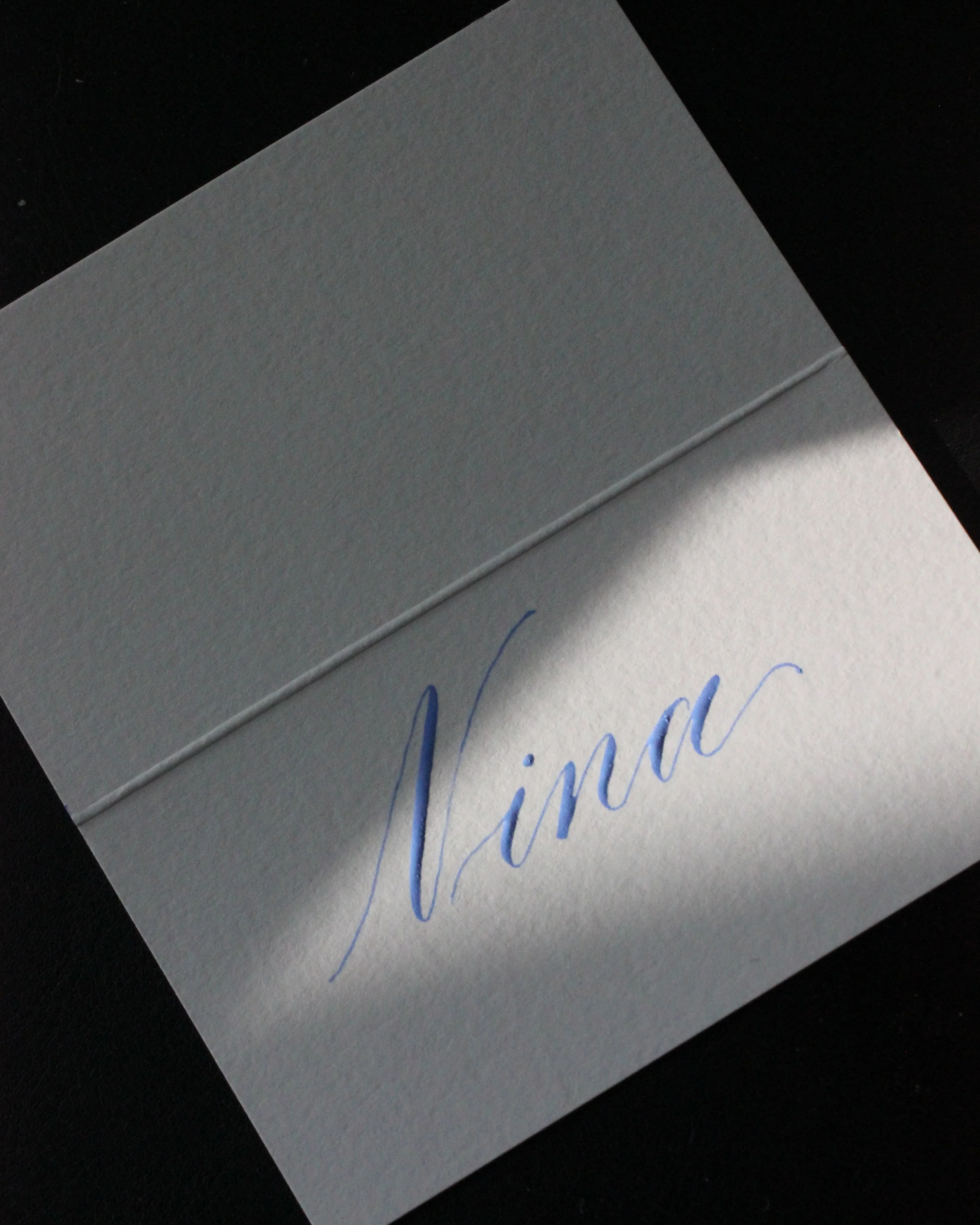 Wedding name card written by hand in modern calligraphy