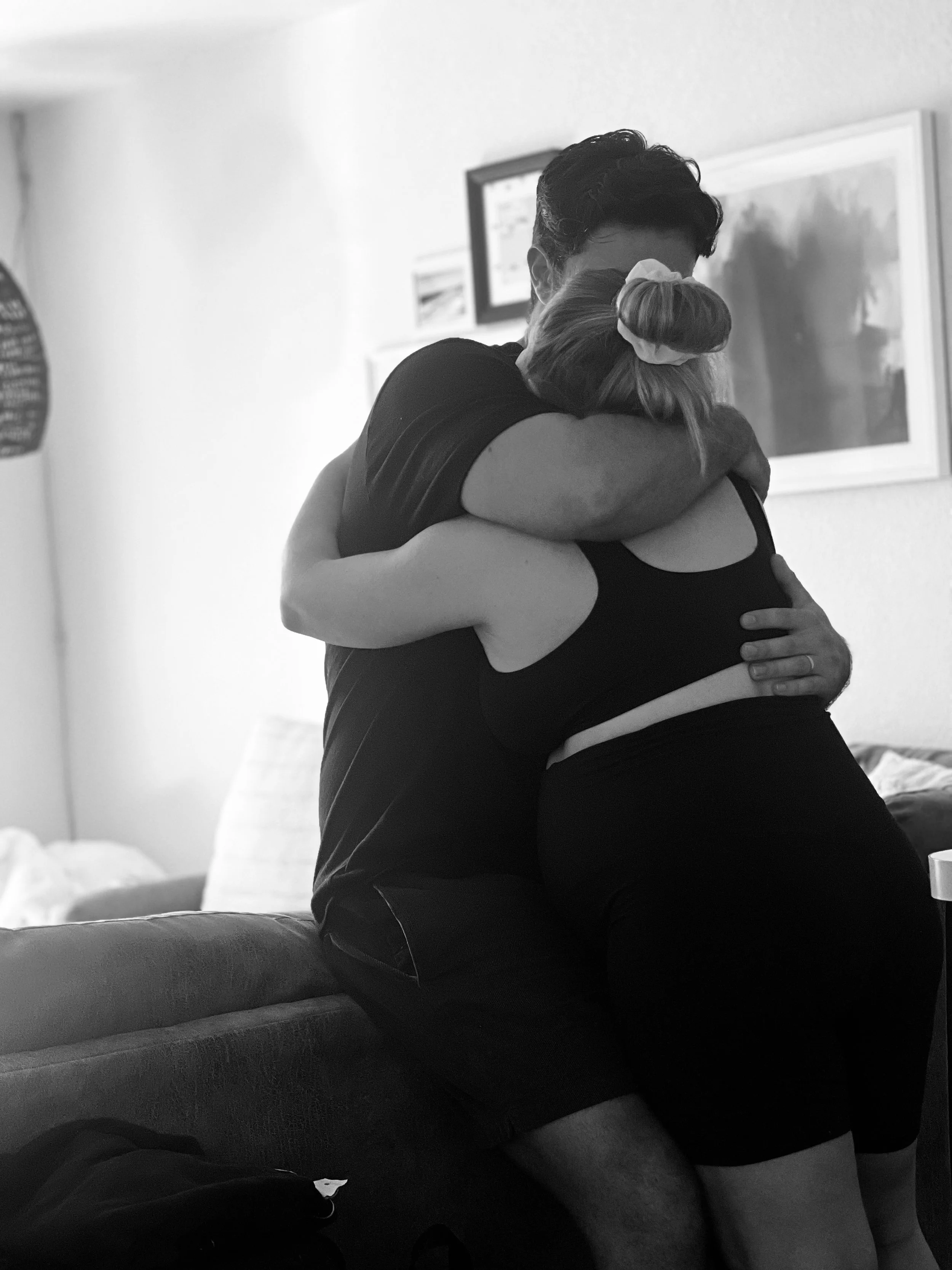 Laurie’s customers, Mariana and Carmen holding hands on a green lawn on their wedding day.