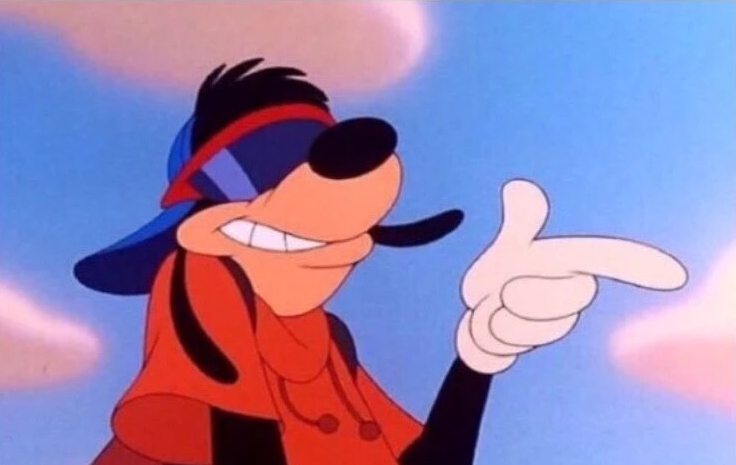 Animated character, a dog wearing a blue and red hat and red bandana, pointing with a confident expression.
