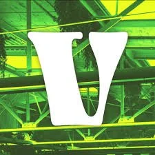 Vivarium logo. White stylized letter V on green-tinted background photo of rafters from inside venue.