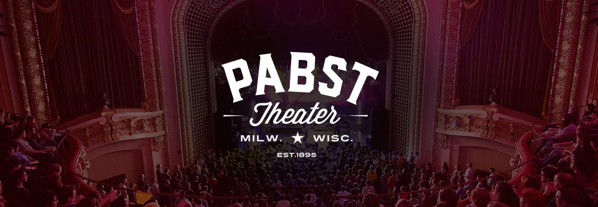 Pabst Theater logo. White text over photo from inside venue.