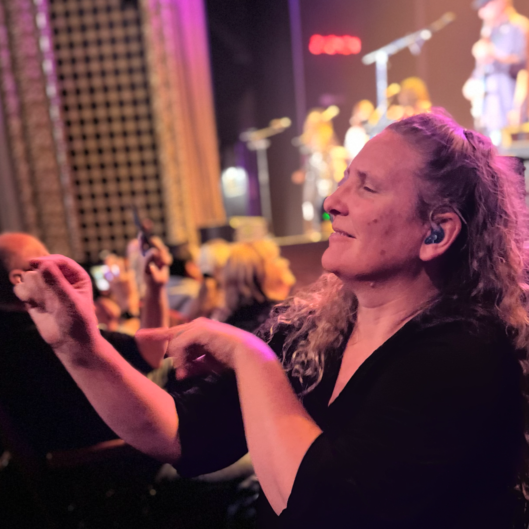 Placeholder image: the ACT Interpreting logo, depicting stylized black lines forming hands signing "interpret" against a mint background.