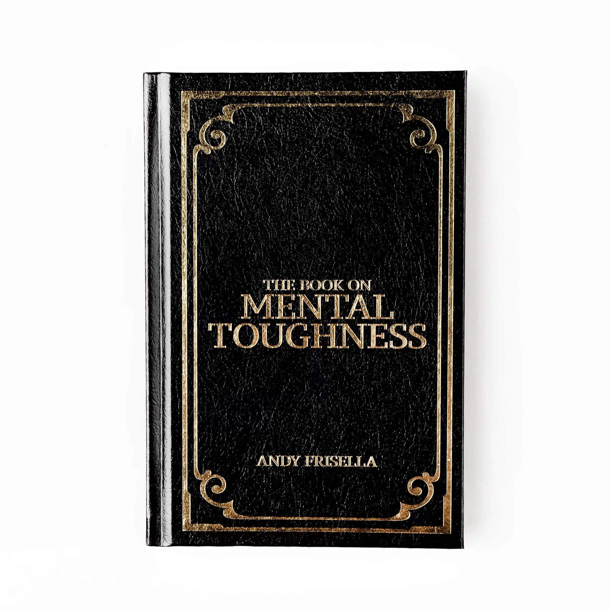 Black hardcover book titled "The Book on Mental Toughness" by Andy Frisella with gold lettering and decorative borders on the cover, placed on a white background.