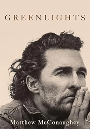 Book cover for "Greenlights" by Matthew McConaughey featuring a black and white photo of the actor with hands pressed together near his face.