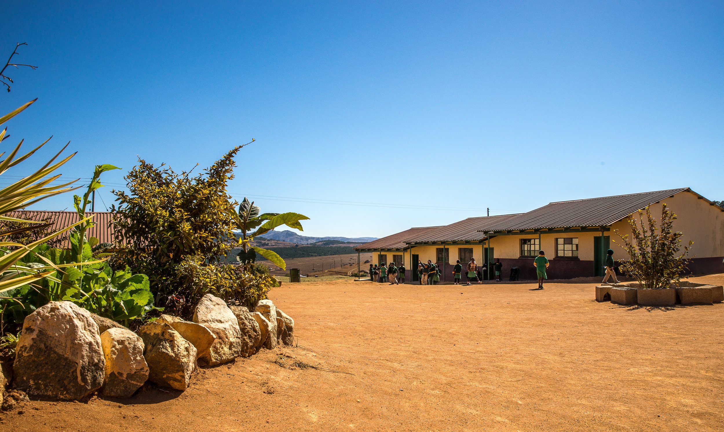 wide-angle-shot-houses-built-dry-field-few-plants.jpg