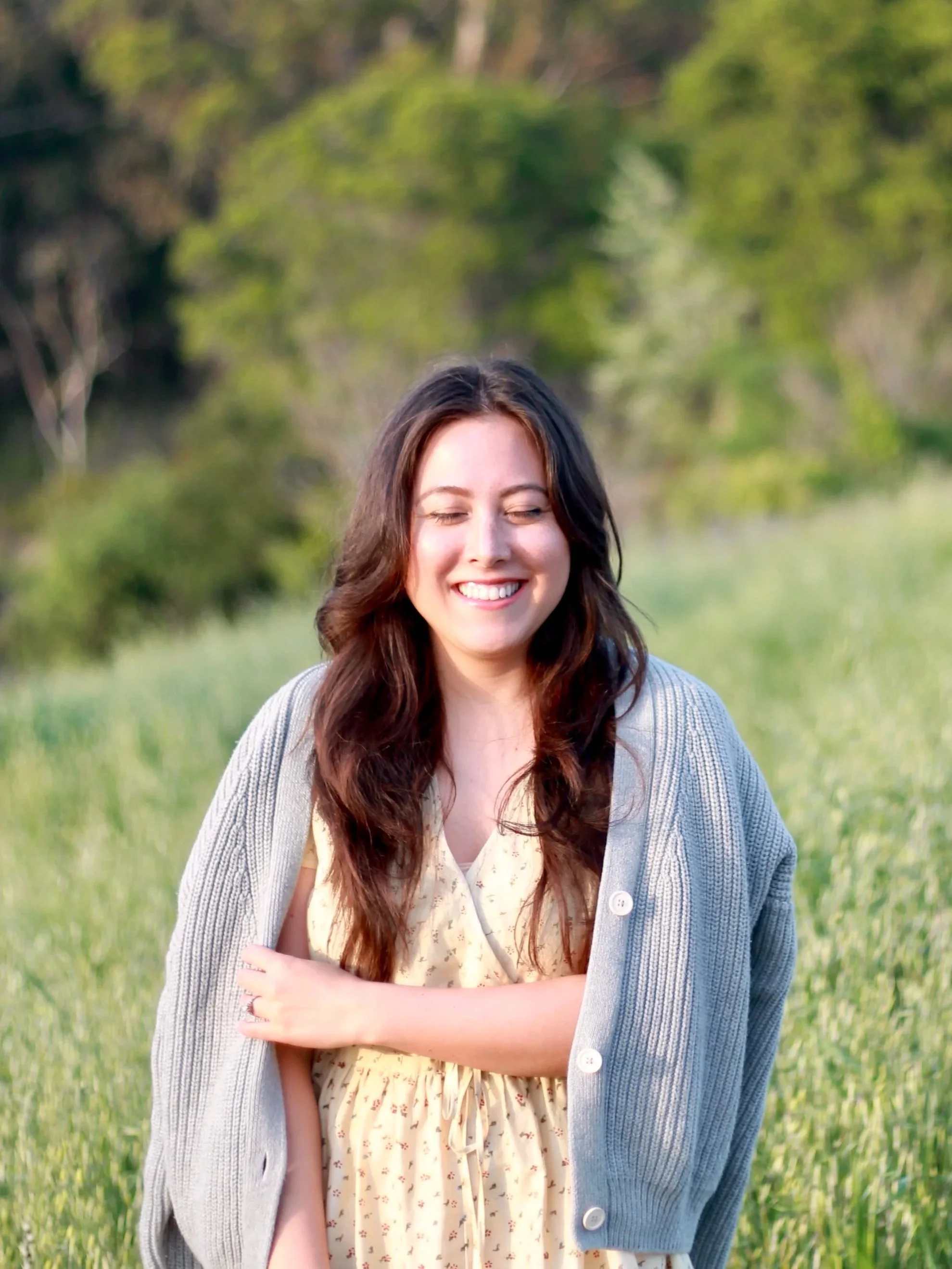Therapist Caitlin Blair welcoming clients into serene, nature-inspired virtual therapy space in California.