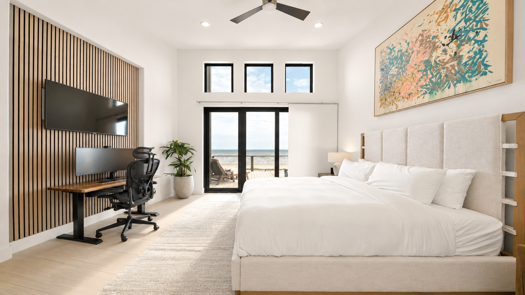 Modern bedroom with desk, balcony, ocean view, and layered FF&E selected for comfort, function, and elevated property presentation.