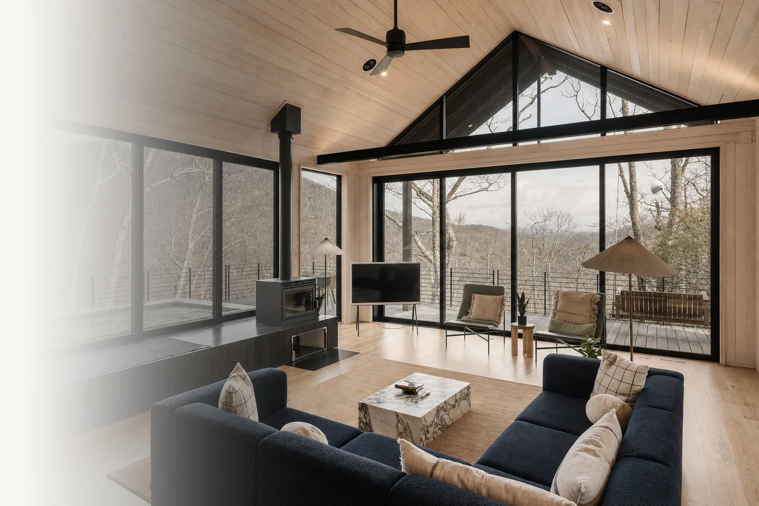 Luxury living room with floor-to-ceiling windows, lounge seating, and FF&E selected for comfort, scale, and high-end residential use.