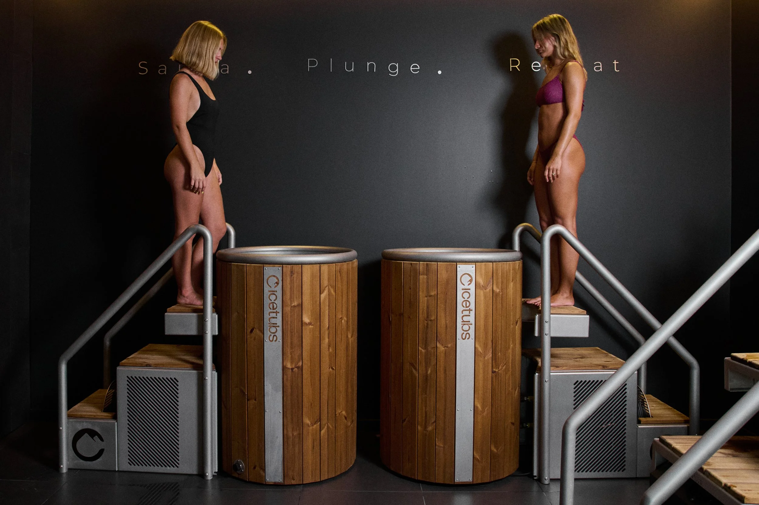 Two guests stepping into the ice plunge tubs at Ladata