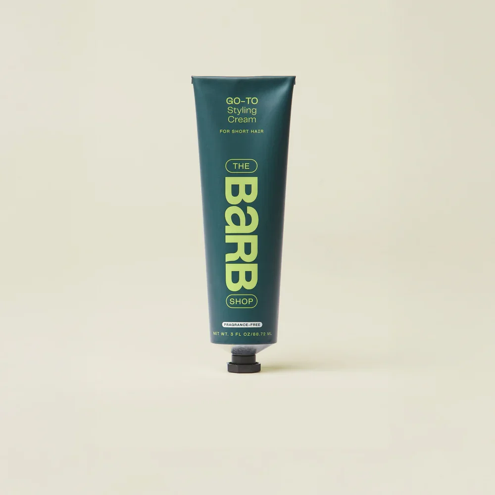 A green tube of hairstyle styling cream labeled 'The BARB Shop' standing upright against a plain background.