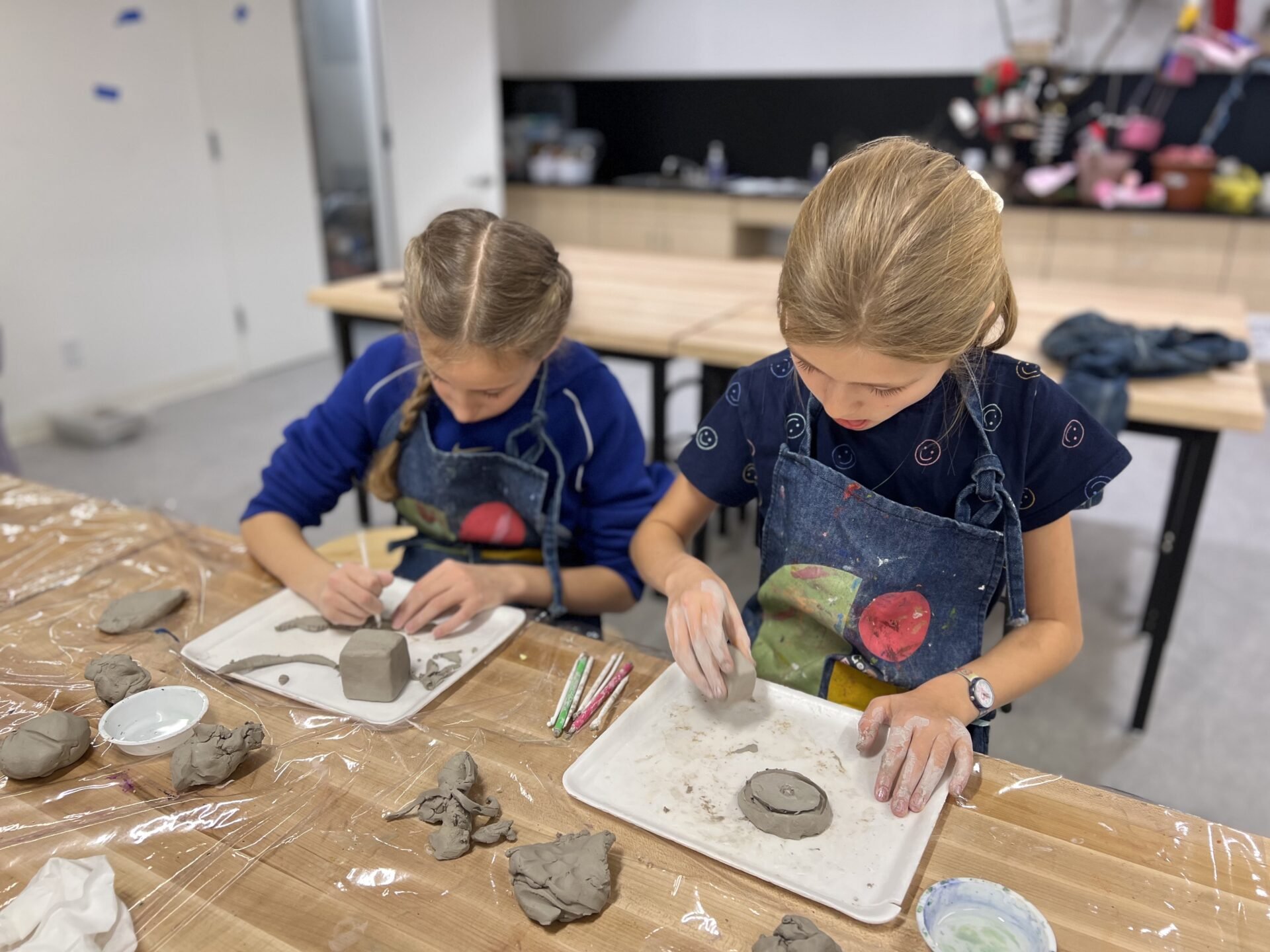 Two students working with clay in the art room