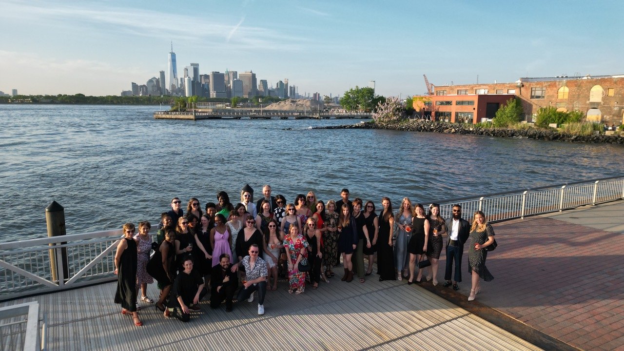 German school Brooklyn community members standing near a body of water