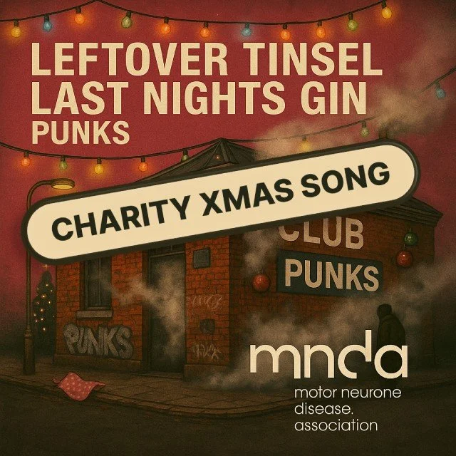 A promotional poster for a charity Christmas song event by the Motor Neurone Disease Association, featuring a dark brick building with graffiti, some smoke, and colorful string lights overhead. Text indicates the event involves left over tinsel, last nights gin, punks, and a club punk scene.