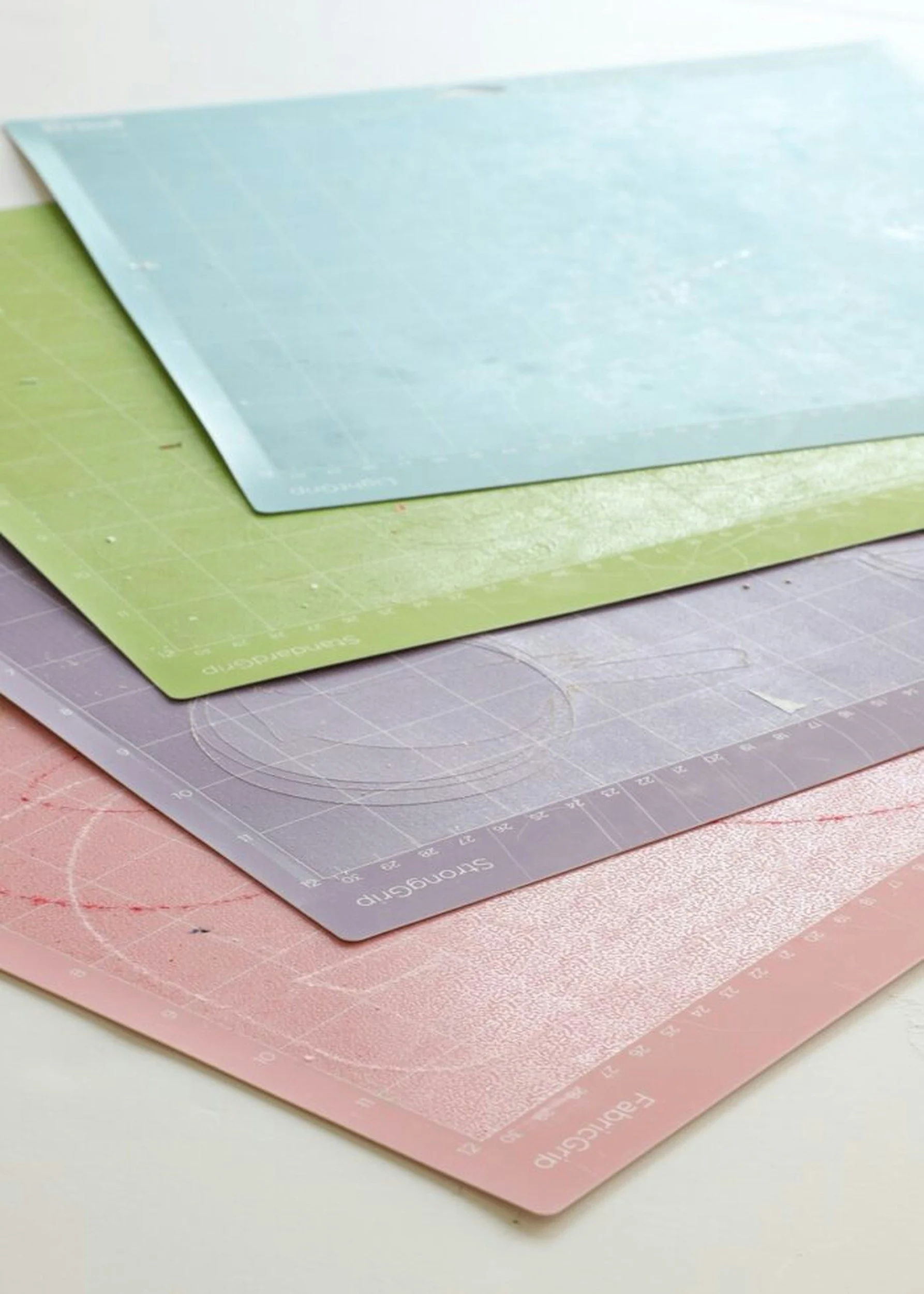 Several colorful silicone baking mats stacked on top of each other.