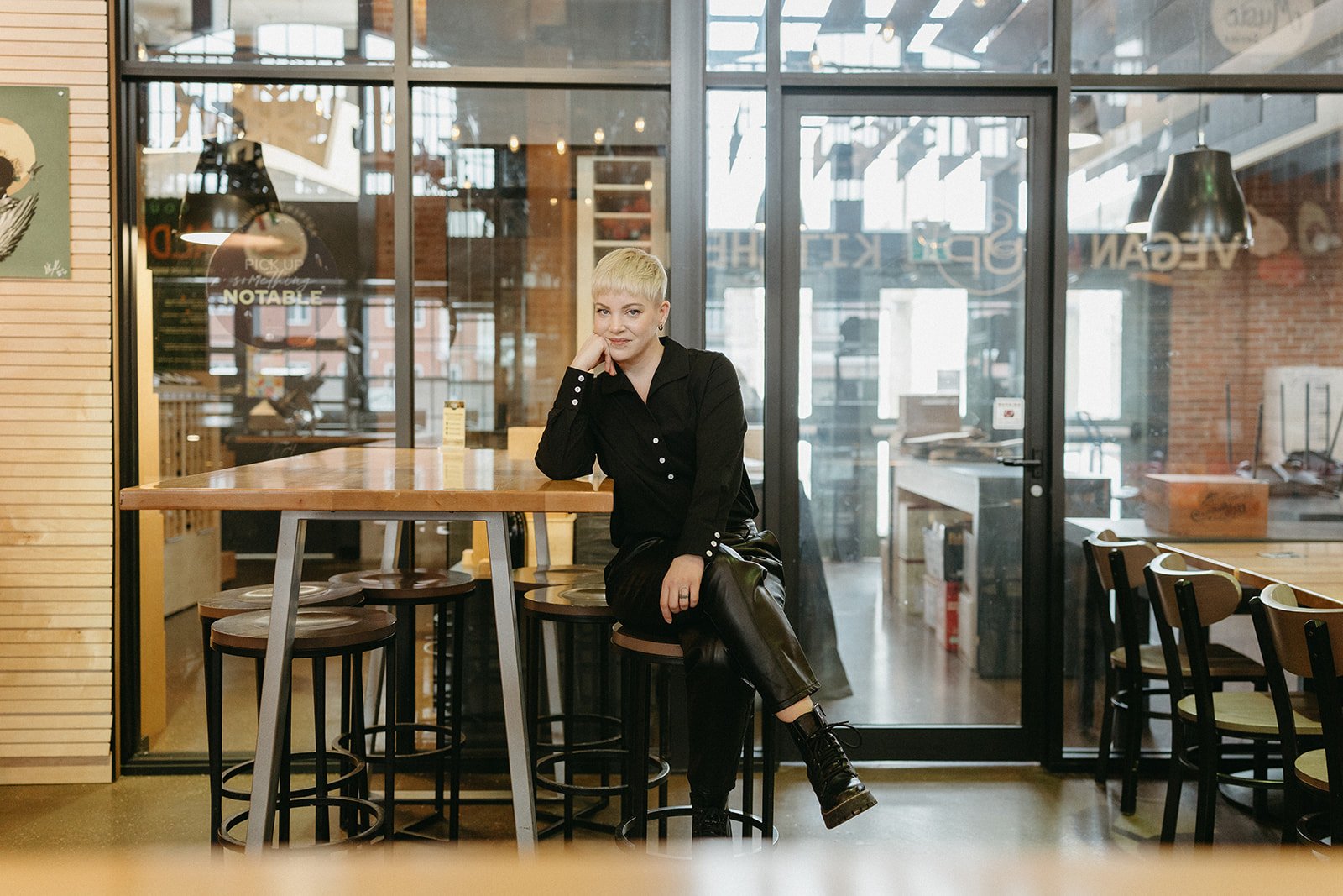 An SEO expert sits on a stool inside Founders Food Hall in Charlottetown, PEI practicing what she preaches about investing in visibility