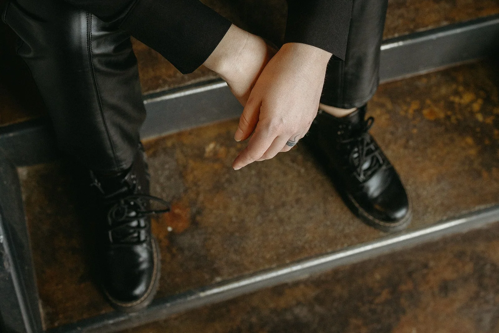 A close-up of real estate SEO strategist Jen Standing's hands and shoes