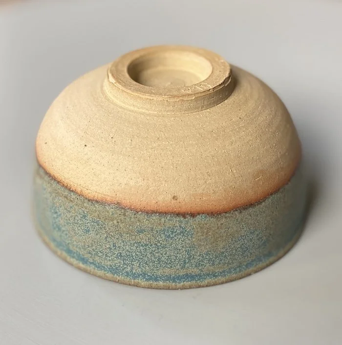 unique hand built small medium bowl. Subtle blue glaze inside half outside toasted buff stoneware, one-off
