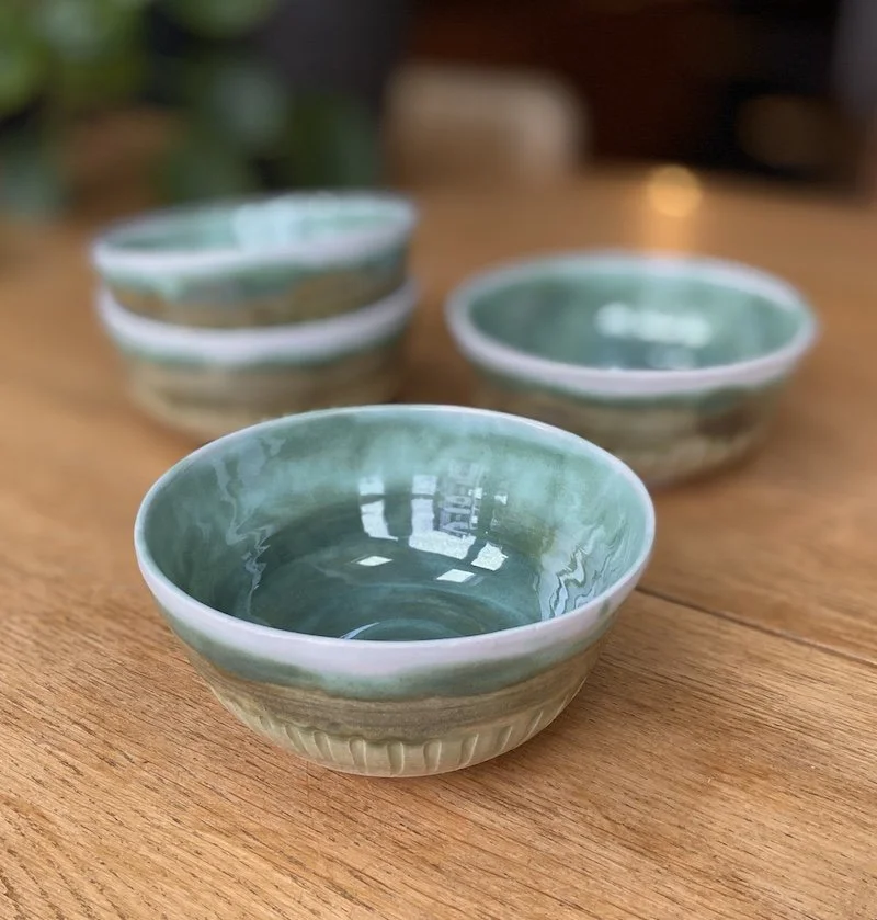 unique hand built medium bowl. Glossy teal green and white glaze with carved detail. White stoneware, unique