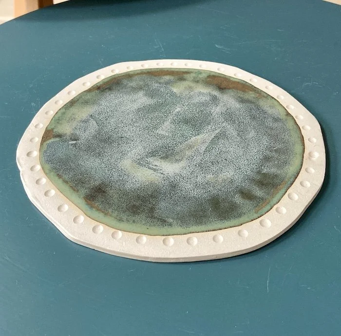 Glossy flat side plates in an unusual glaze multi tones of blue and bronze. textures flow beautifully over carved details. Hand made slabbed, cut by hand for a unique shape. (Copy)