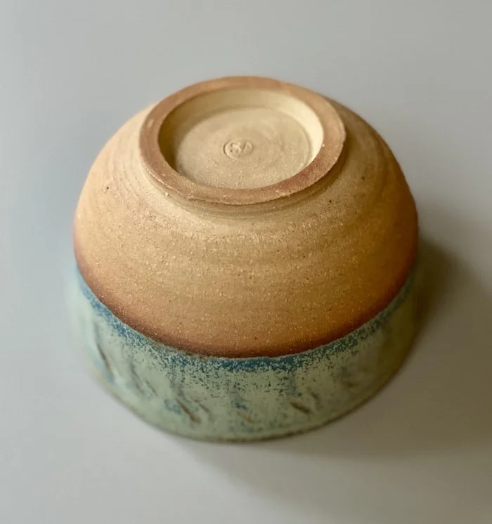 unique hand built medium sized bowl. Subtle blue glaze inside half outside toasted buff stoneware, one-off, hand carved