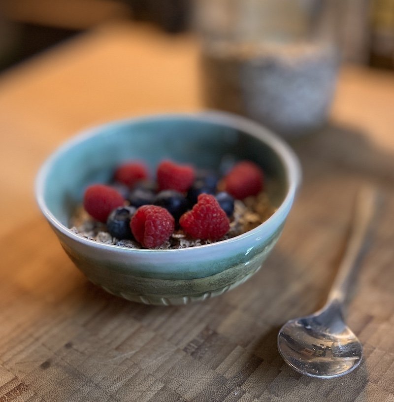 unique hand built medium bowl. Glossy teal green and white glaze with carved detail. White stoneware, unique