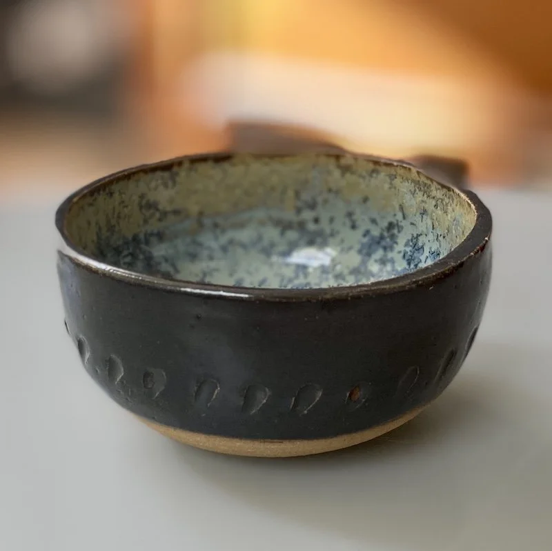 unique, one-off piece, small bowl for serving snacks, dips and olives. Glossy black glaze outside contrasts with natural bare stoneware with a beautiful turquoise, green and crystallised inside.