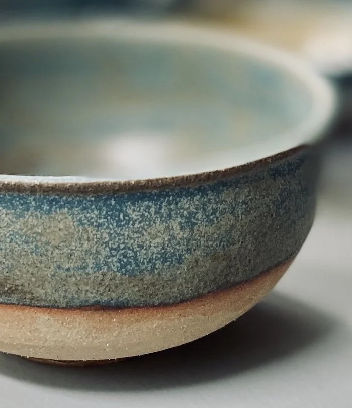 unique hand built small medium bowl. Subtle blue glaze inside half outside toasted buff stoneware, one-off