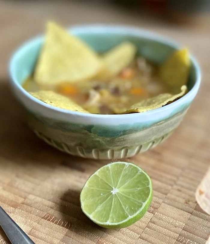 unique hand built medium bowl. Glossy teal green and white glaze with carved detail. White stoneware, unique