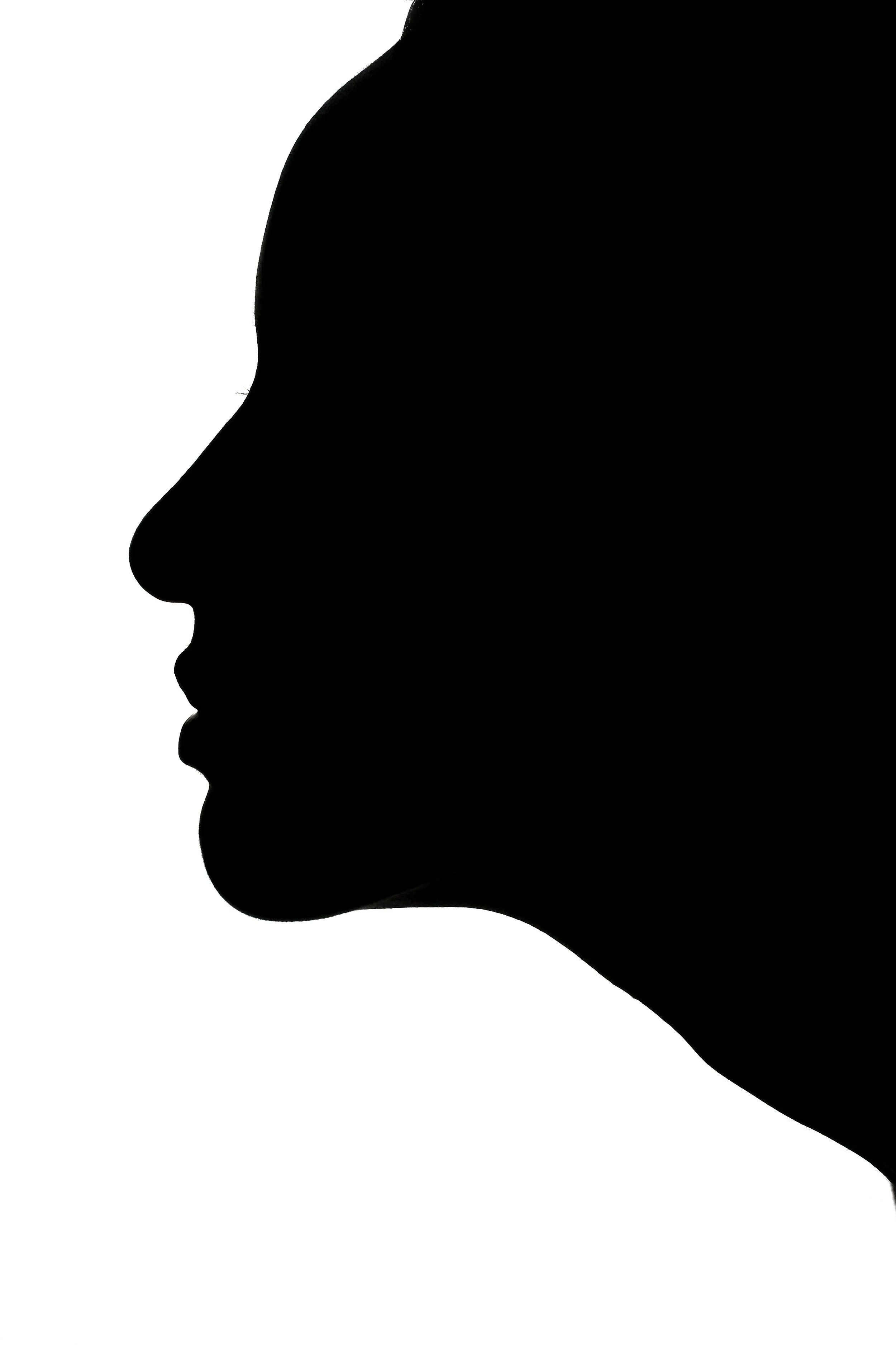 Silhouette of a woman's face in profile against a white background.