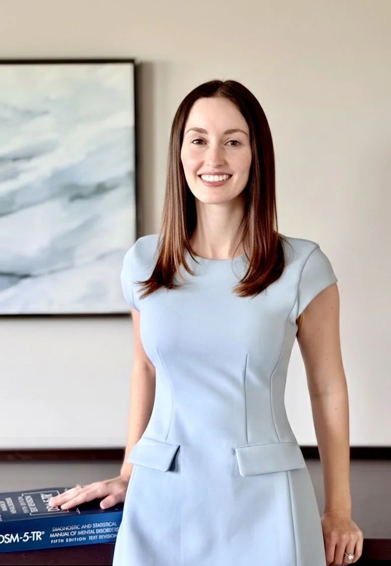 Dr Betterly Smiling Next To DSM Book