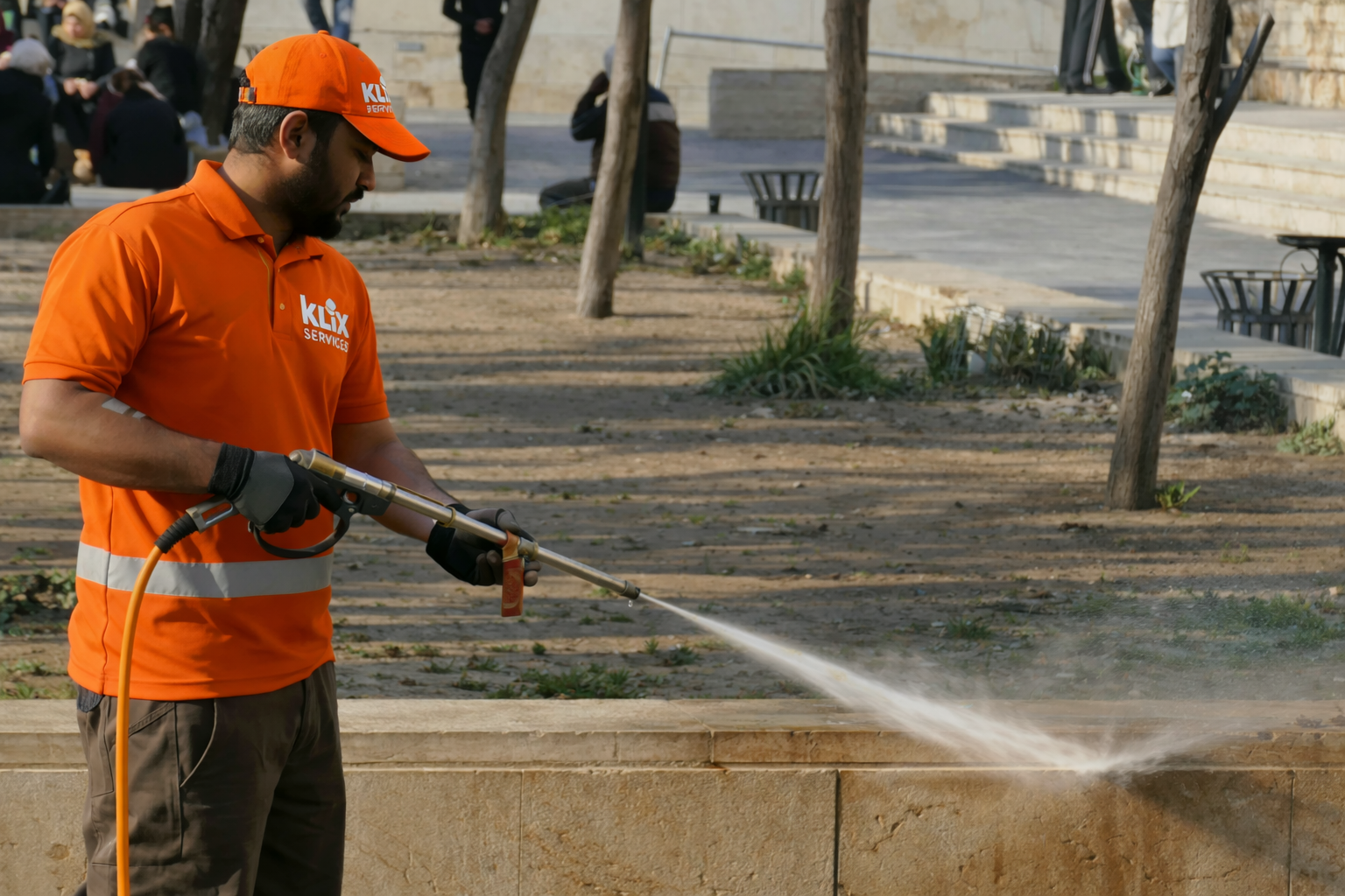 klix worker pressure washing sidewalk