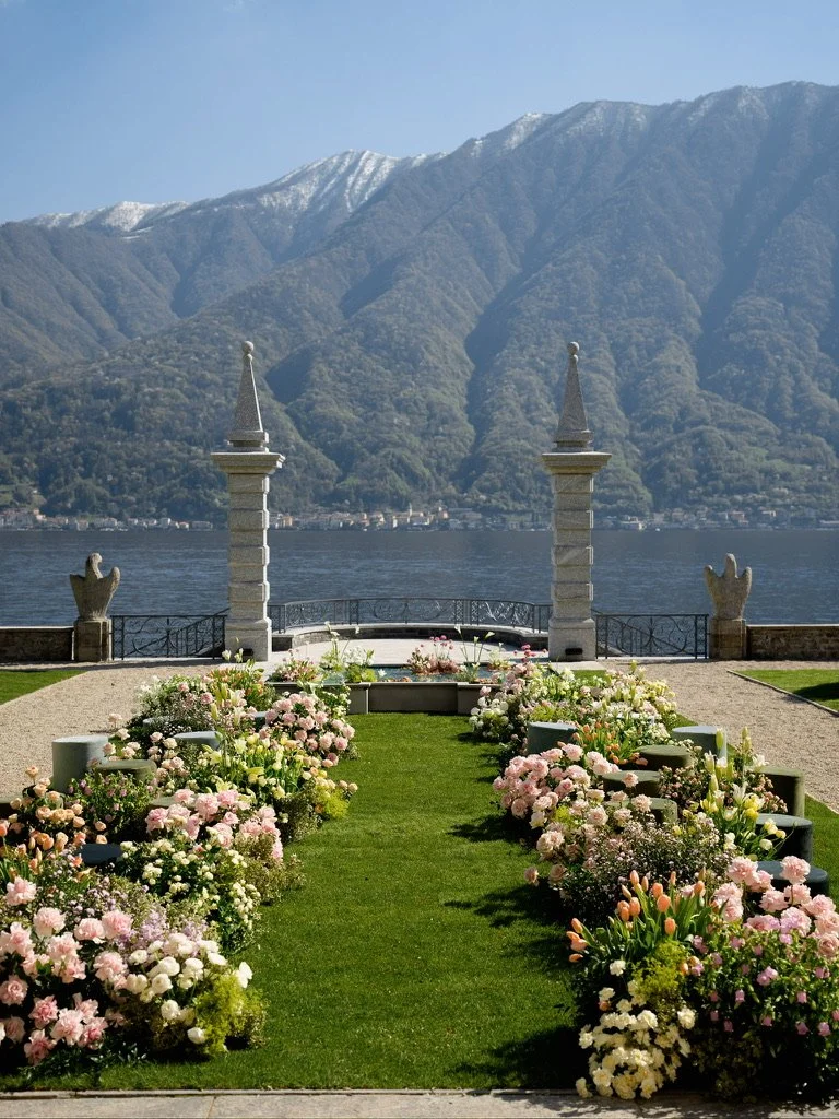 Pastel garden roses, tulips and lilies lining a ceremony aisle toward the lake and snow-capped mountains