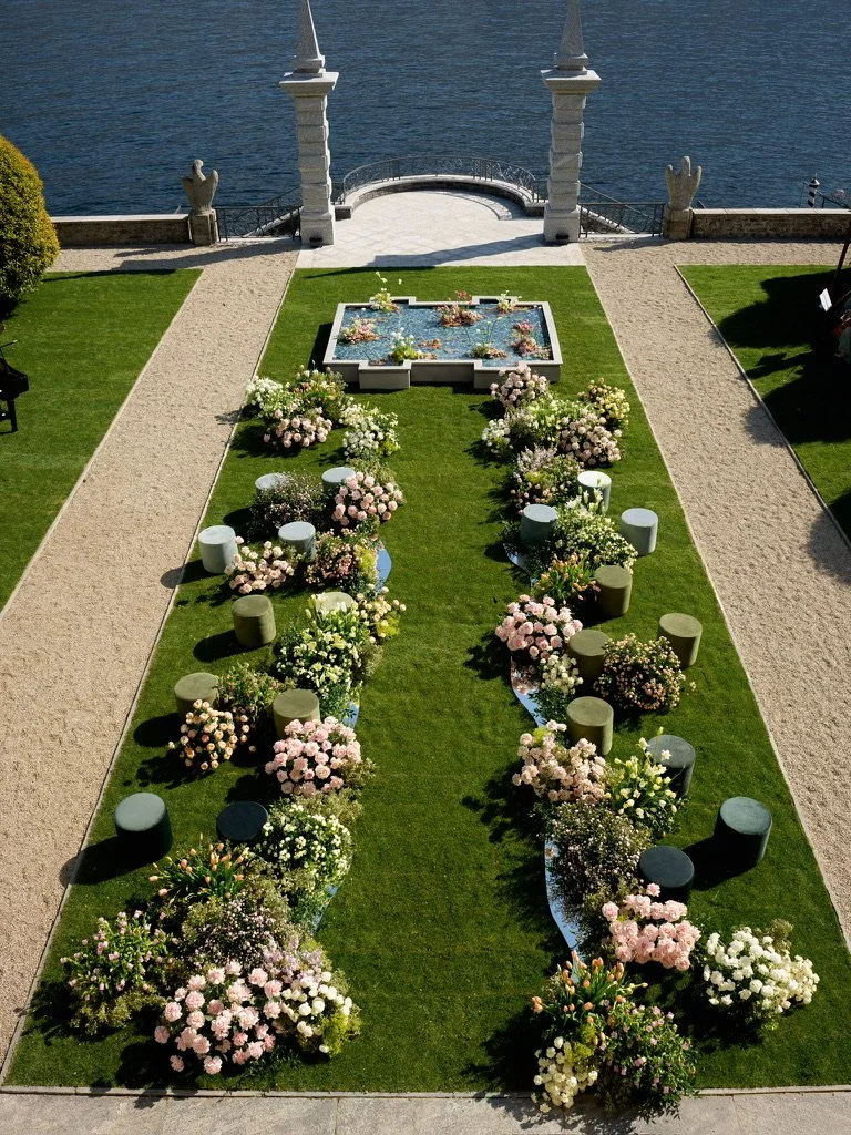 Aerial view of the ceremony aisle with mirrored streams flowing toward a flower-filled pond by Lake Como