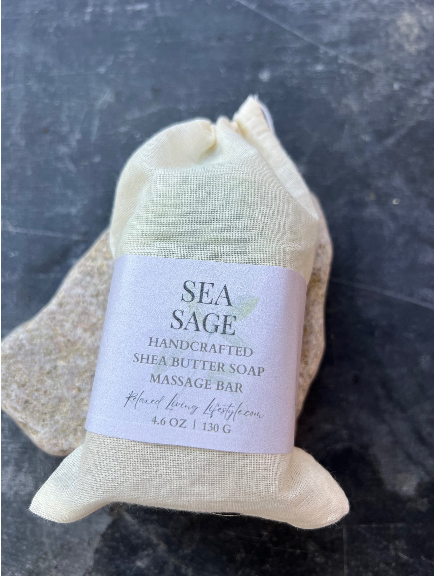 Sea Sage shea butter massage bar styled with a black background lying flat, with notes of lemongrass, sage, and lime, herbal citrus artisan soap by Relaxed Living Lifestyle