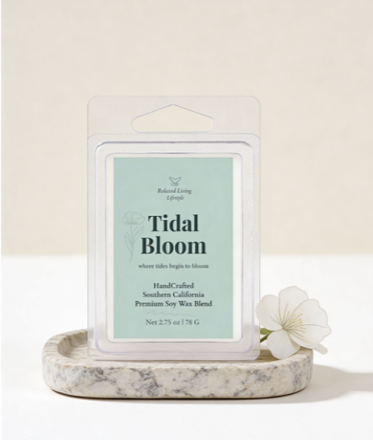 Tidal Bloom wax melt cubes styled on a textured stone dish with delicate florals, set against a neutral background to highlight the coastal floral scent and minimalist, nature-inspired design.