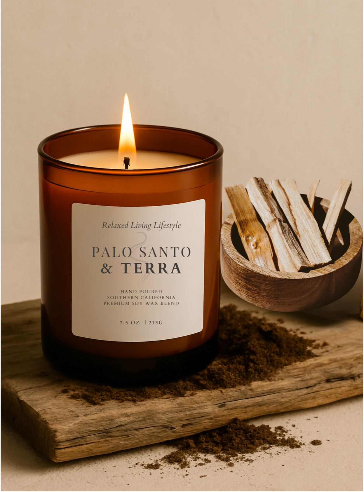 Lit Palo Santo & Terra candle burning with warm flame, featuring grounding scent notes of patchouli, palo santo, and violet in a beautiful vessel