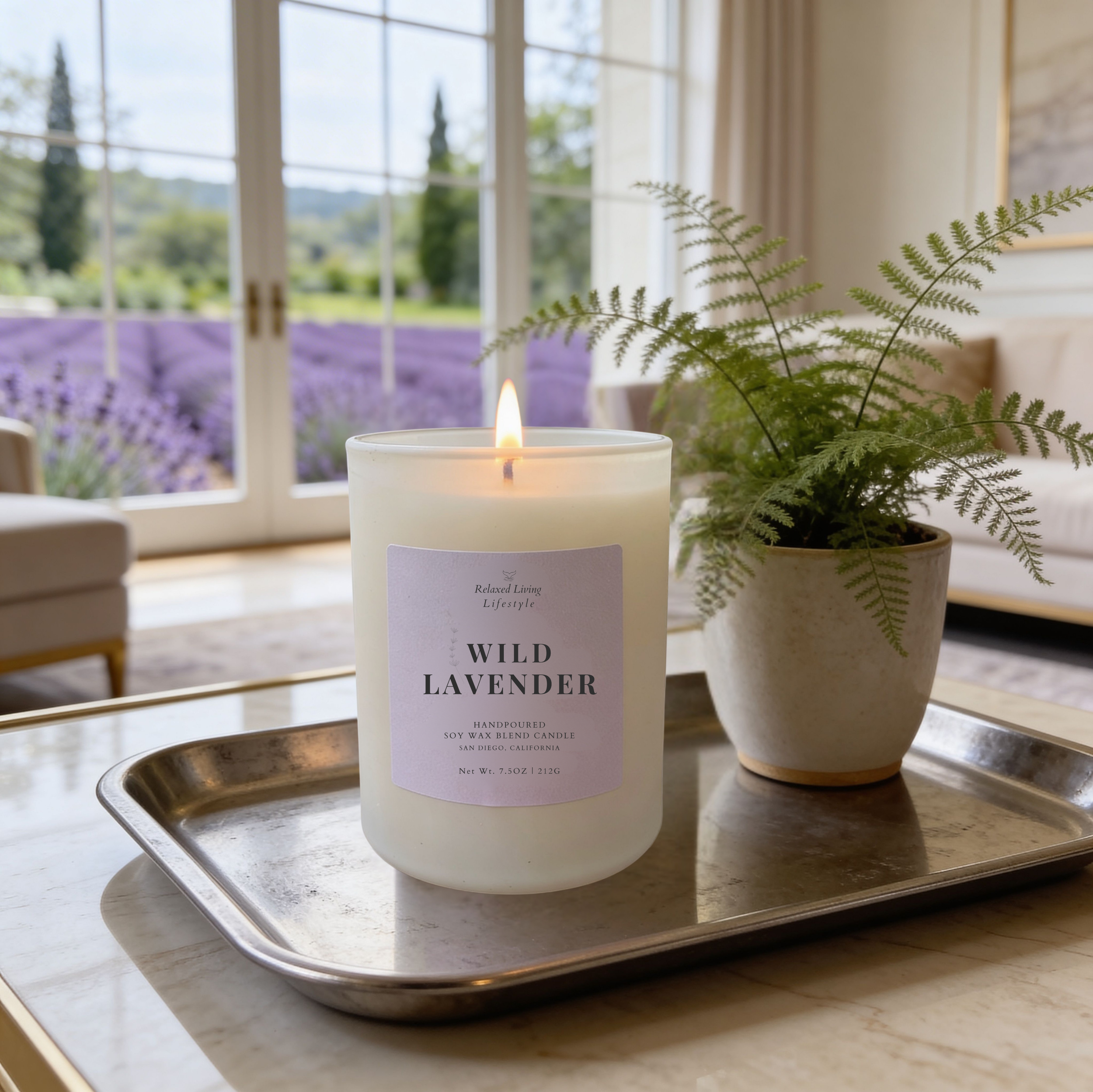 Lavender soy candle on a metal tray with a decorative plant, styled near a window with a lavender view creating a calm home fragrance setting