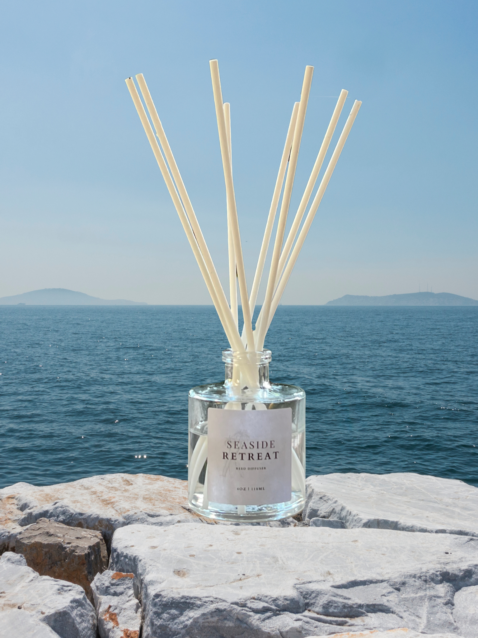 Seaside Retreat reed diffuser with notes of bergamot, sea salt, & peony. A refreshing coastal fragrance with soft florals and clean musk