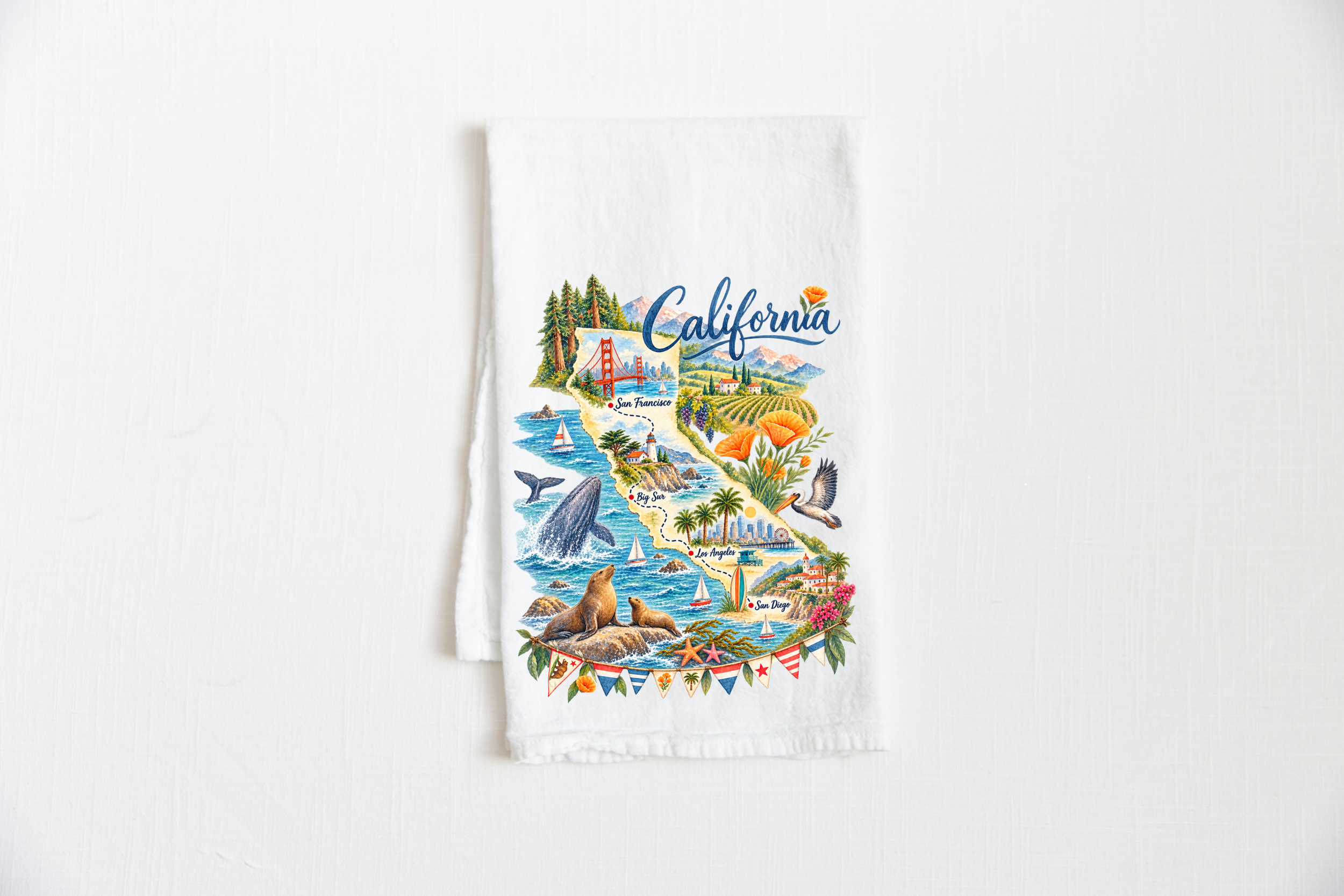 White cotton California tea towel featuring a colorful illustrated state design with coastal scenery, redwoods, California poppies, wildlife, vineyards, and landmarks from San Francisco to San Diego.