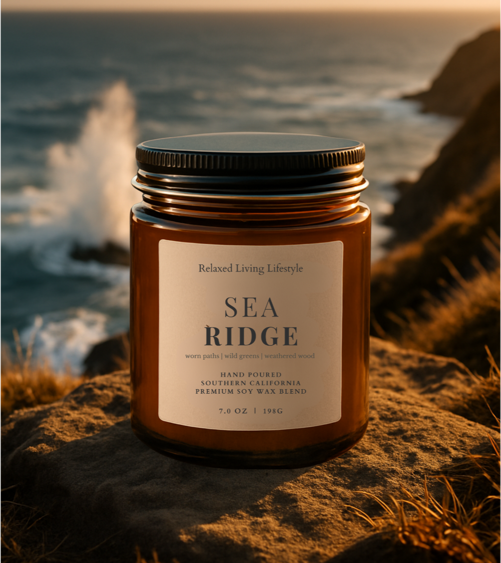 Sea Ridge soy wax blend candle with lid on, styled on ridge overlooking the sea