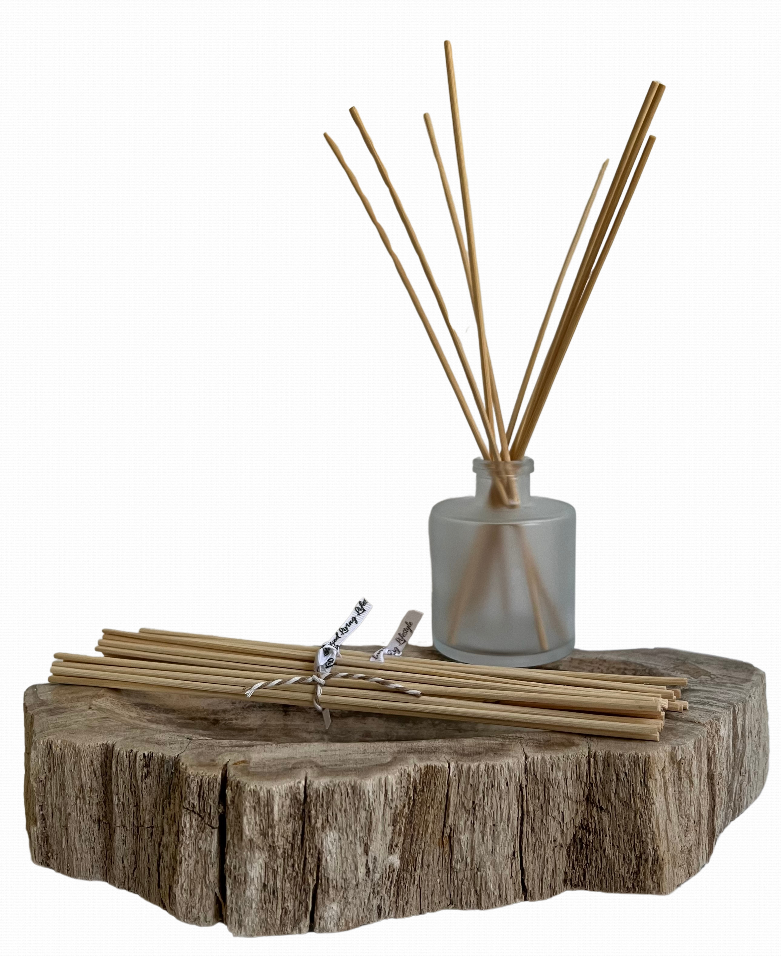 10 pack of natural rattan diffuser reeds displayed on a tray, with a reed diffuser in the background showcasing the eco-friendly, responsibly harvested reeds for optimal scent diffusion.