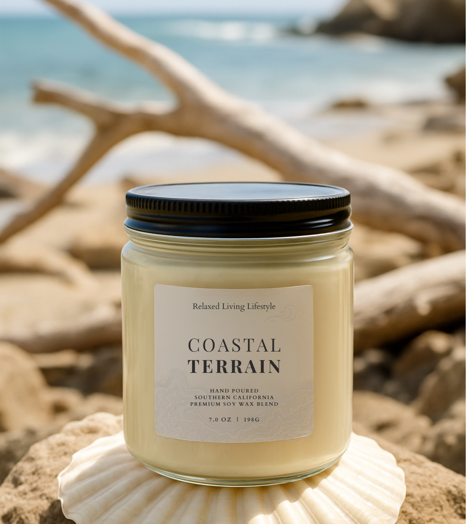 7 oz Coastal Terrain candle with notes of sea salt, and cedar displayed against rugged coastal landscape