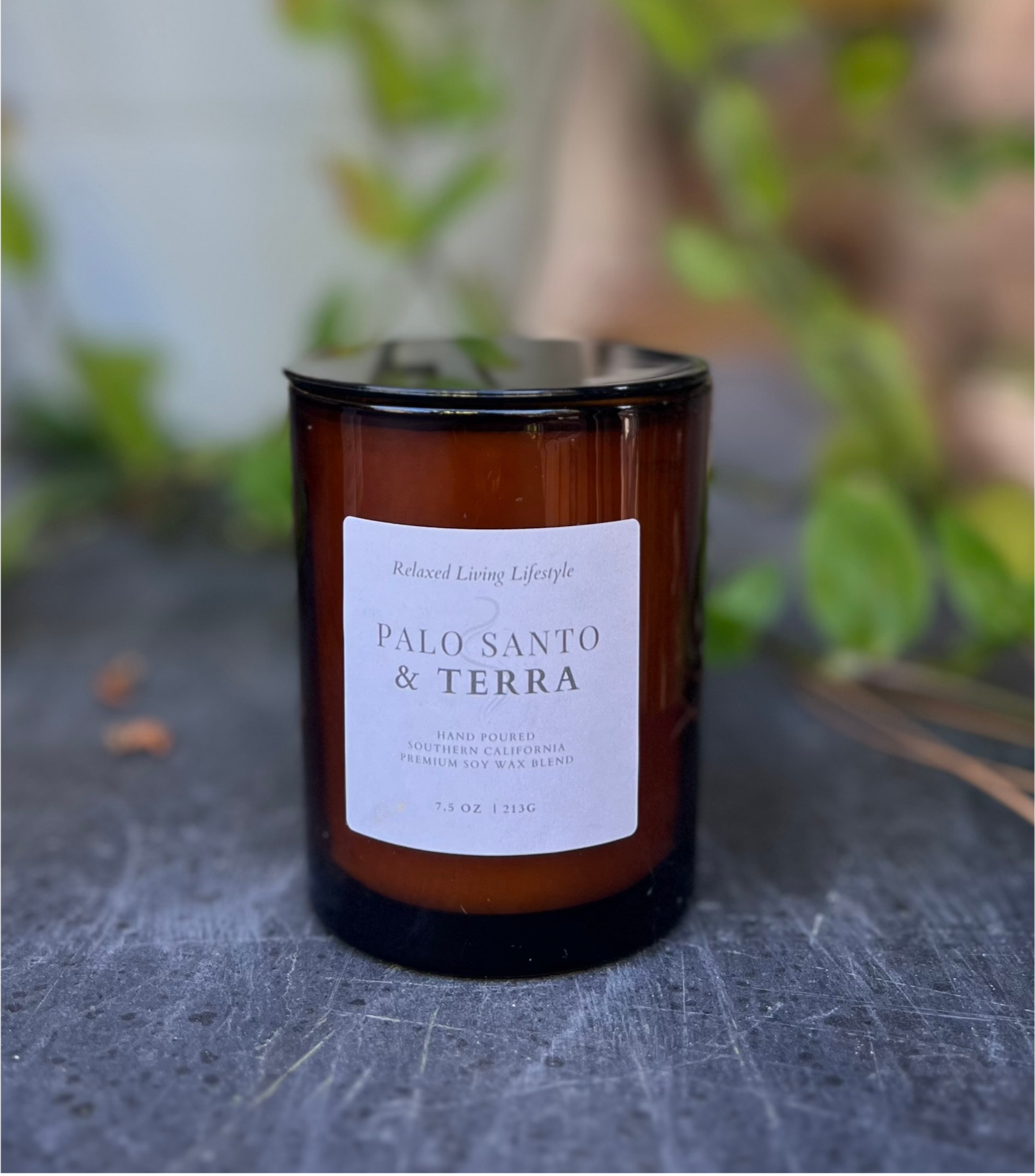 Palo Santo & Terra candle in 7.5 oz vessel with lid on, hand-poured small batch candle with earthy notes of moss, sandalwood, and incense