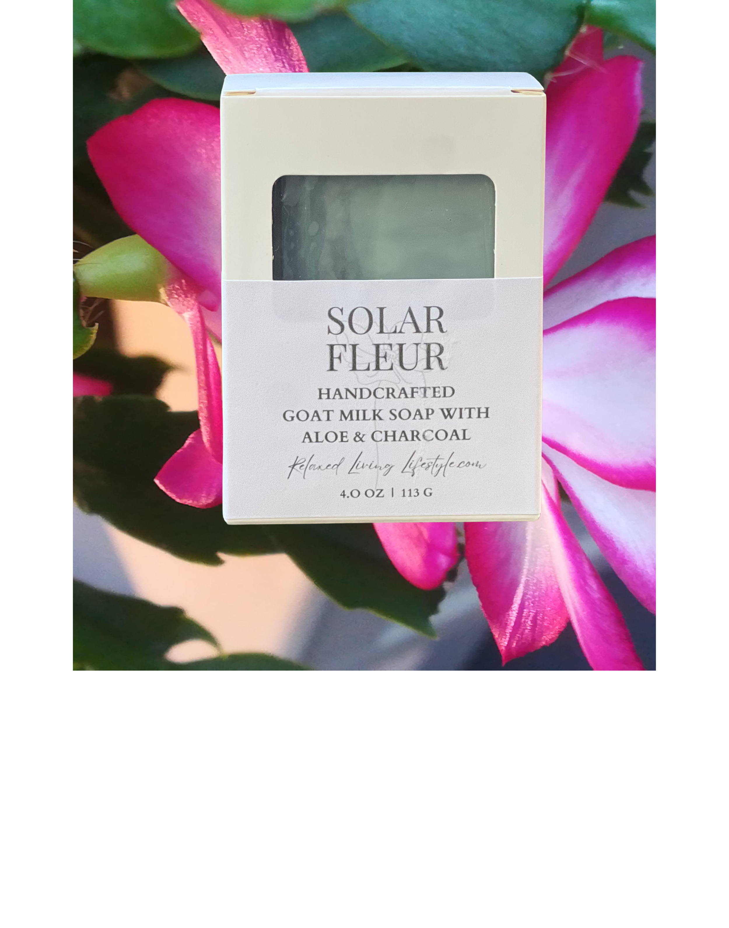 Solar Fleur goat milk soap bar with aloe and charcoal, featuring soft coastal tones and artisan packaging