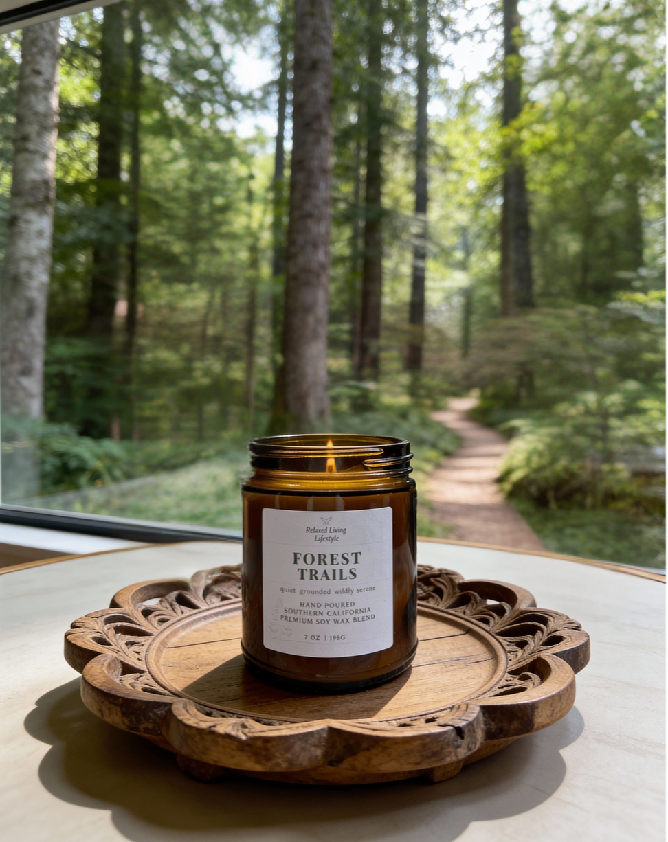 Forest Trails reed diffuser styled on a tray, surrounded by forest and trail scenery, featuring fresh citrus, earthy greens, and warm wood notes