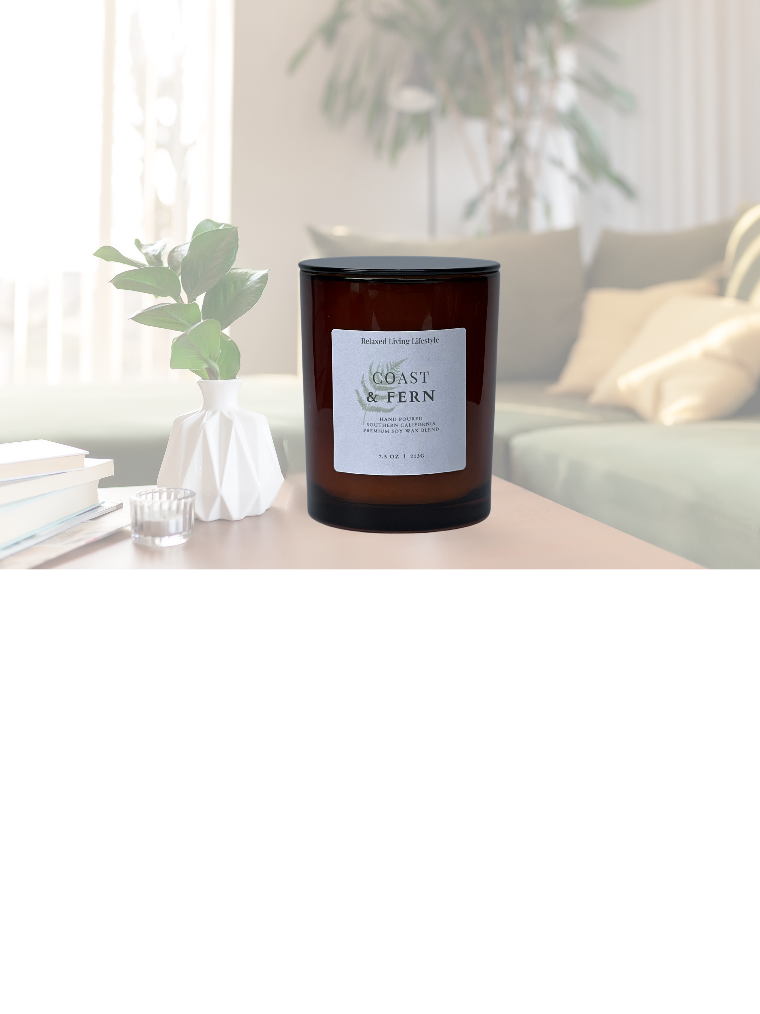 7.5 oz Coast & Fern candle in amber glass vessel with coastal-nature inspired fragrance of ozone, bergamot, lavender, moss, and juniper on a clean natural surface.